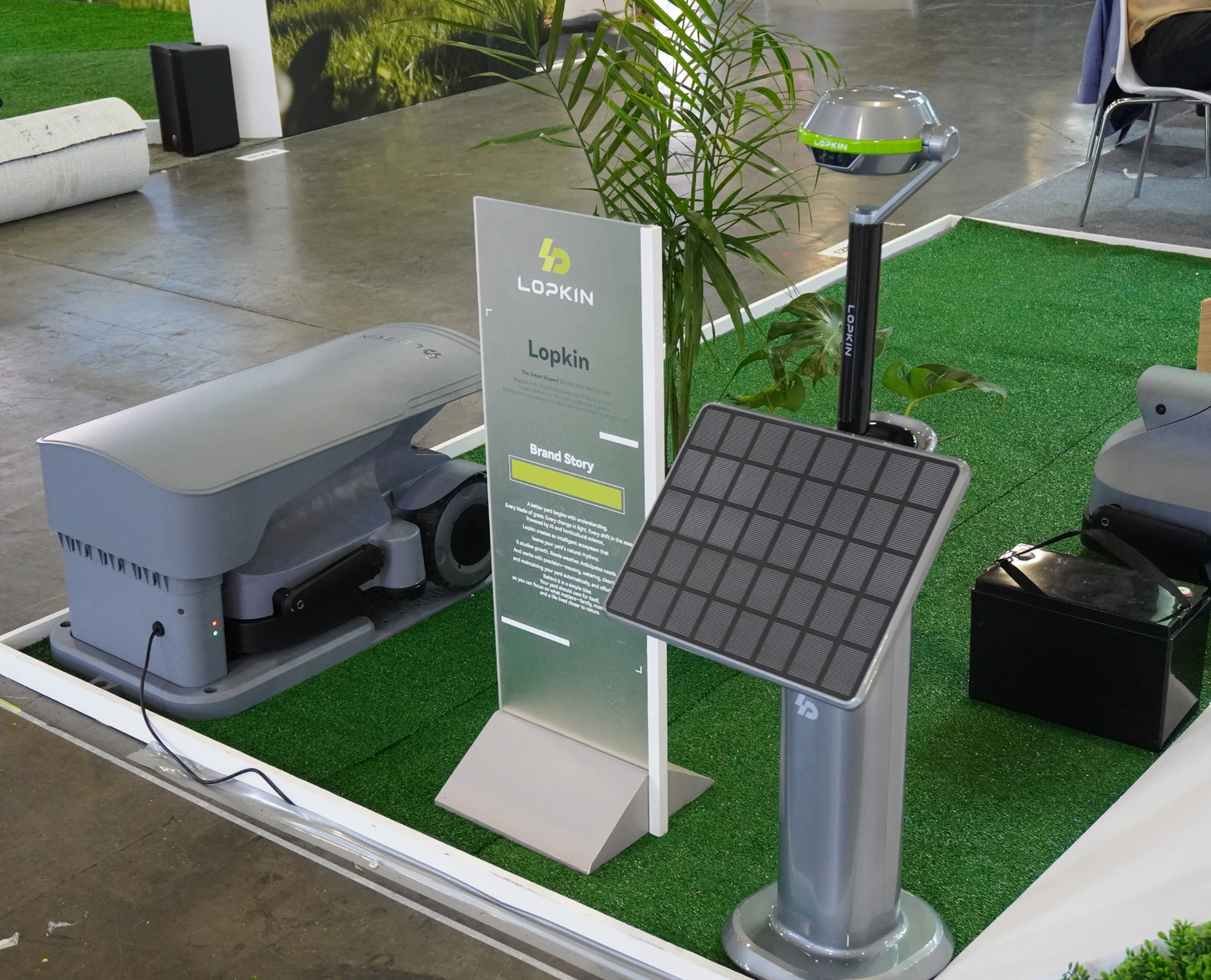 Robotic mower and solar charging display at a LOPKIN exhibition stand